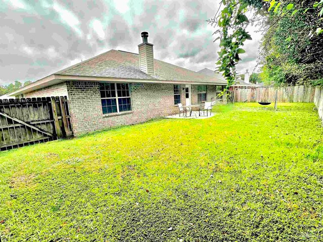 exterior space with a lawn and a patio