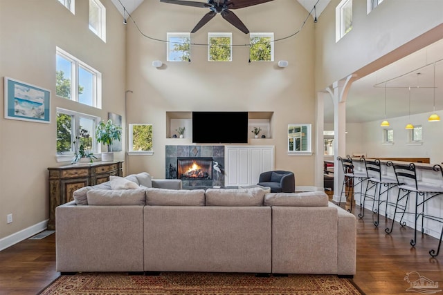 living room featuring a wealth of natural light, dark hardwood / wood-style floors, and high vaulted ceiling