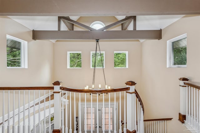 stairs featuring french doors, an inviting chandelier, and lofted ceiling with beams