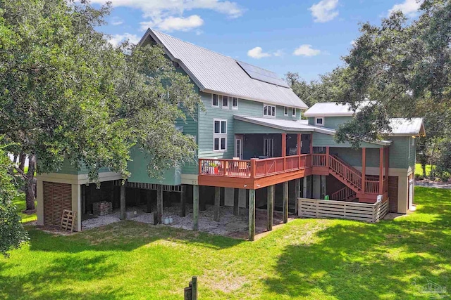 back of property with a lawn and a deck