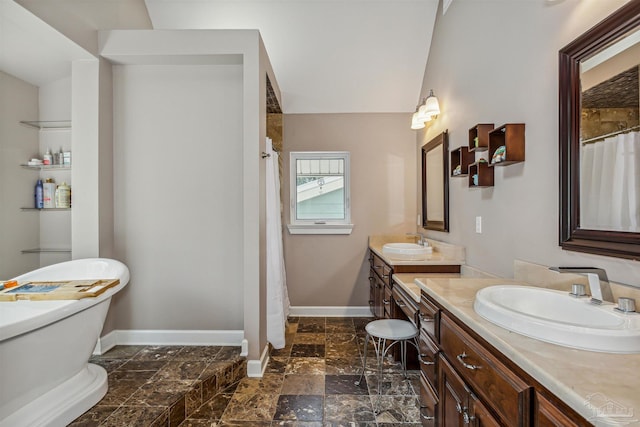 bathroom featuring vanity and lofted ceiling