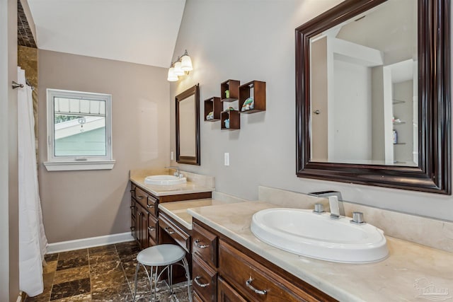 bathroom with lofted ceiling and vanity