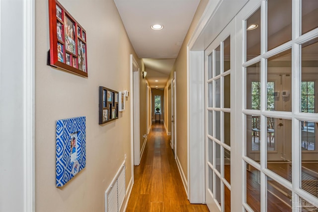 hall with light wood-type flooring and french doors