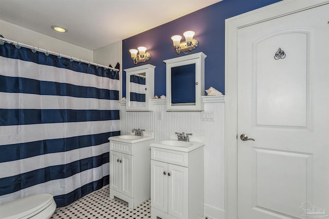 bathroom with tile patterned flooring, vanity, and toilet