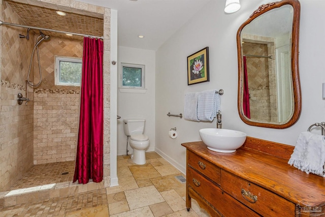 bathroom featuring vanity, curtained shower, and toilet