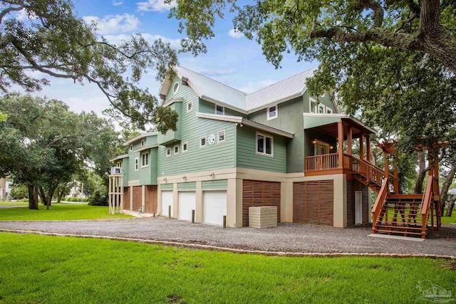 back of property featuring a garage and a yard