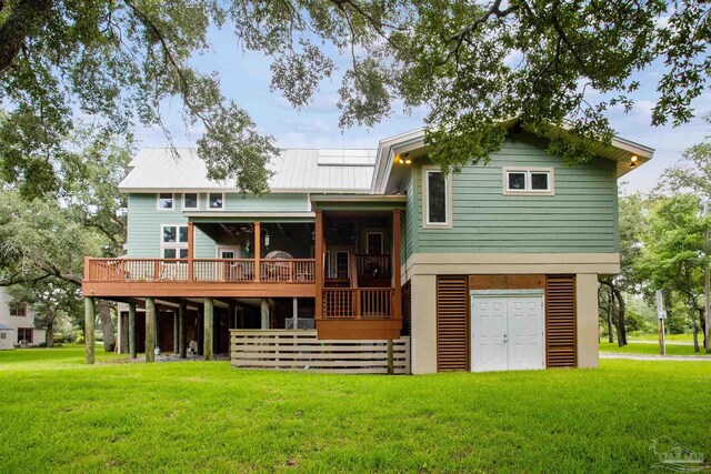 rear view of property with a deck and a lawn