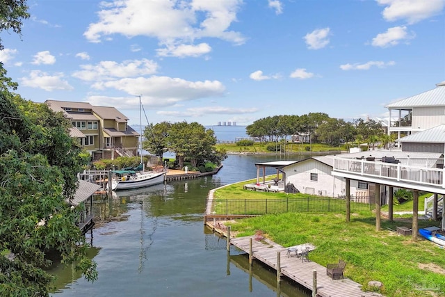 dock area featuring a lawn and a water view