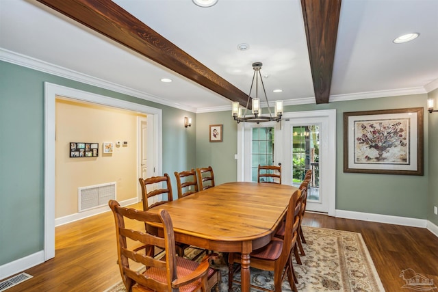 dining space with ornamental molding, a chandelier, beam ceiling, and dark hardwood / wood-style flooring