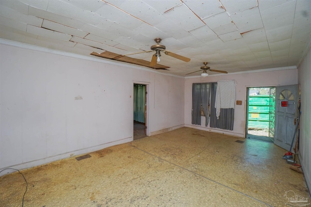 empty room featuring visible vents and crown molding