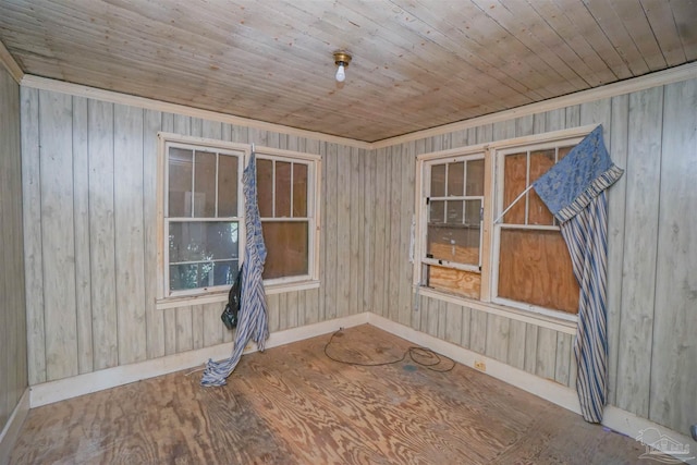 empty room with wooden ceiling, baseboards, and wood finished floors