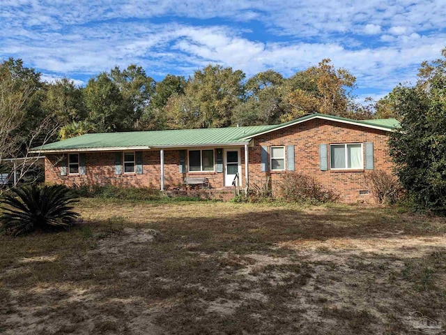 ranch-style house with metal roof, brick siding, and crawl space