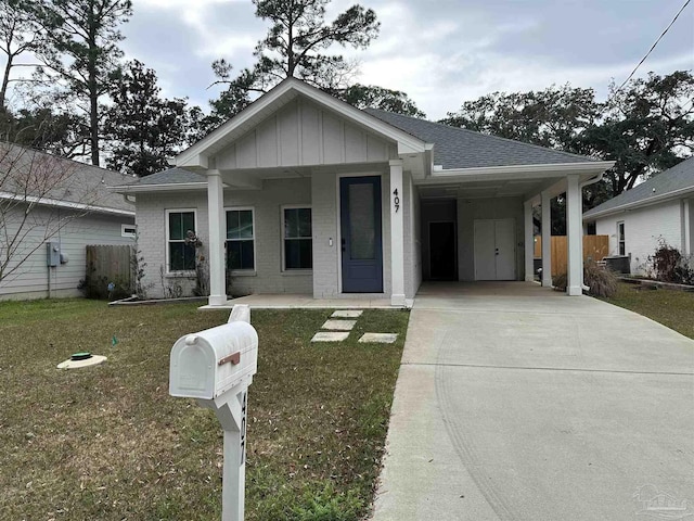 view of front of home with driveway, brick siding, a shingled roof, an attached carport, and a front yard