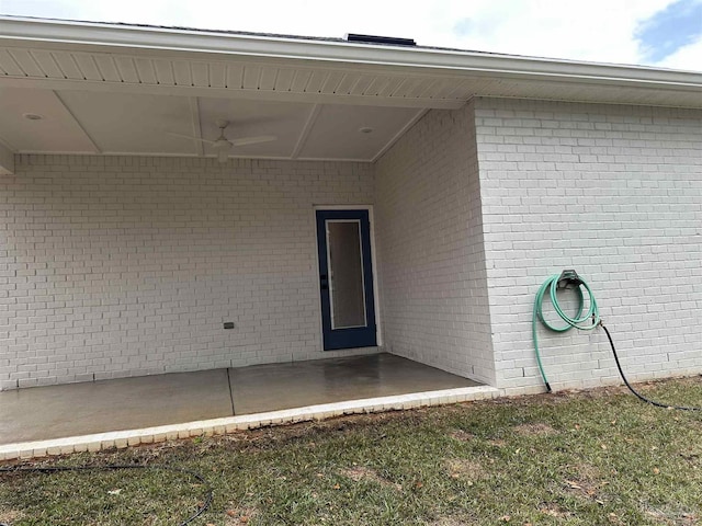 property entrance with a ceiling fan and a patio