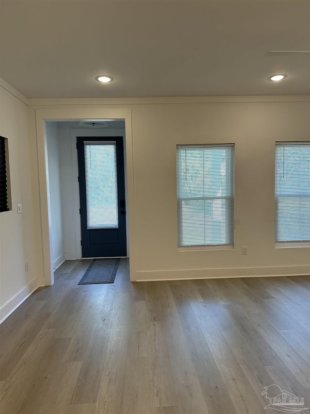 foyer with light wood finished floors, recessed lighting, and baseboards