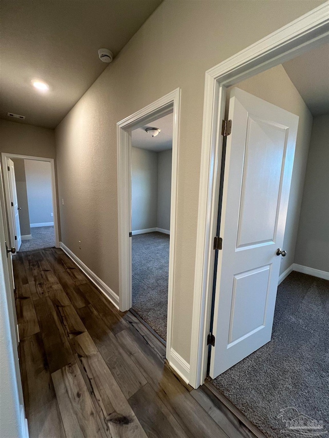 corridor featuring dark hardwood / wood-style flooring