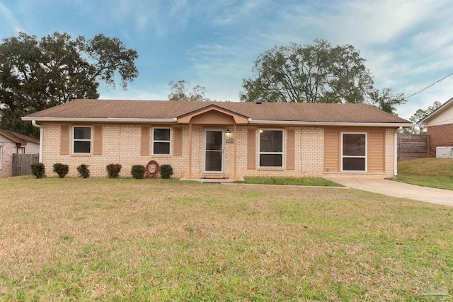 ranch-style home with a front yard and brick siding