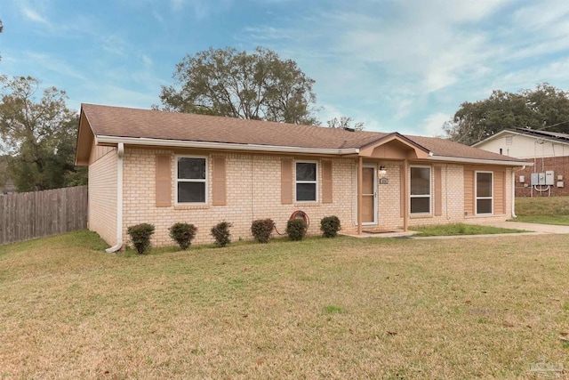 single story home featuring a front lawn, fence, and brick siding