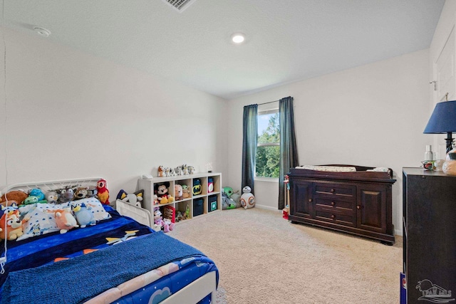 carpeted bedroom with a textured ceiling