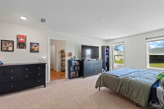 carpeted bedroom with a textured ceiling