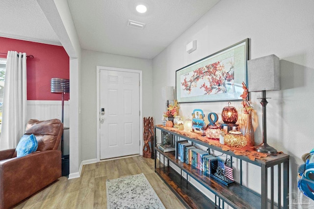 entrance foyer with a textured ceiling and wood-type flooring