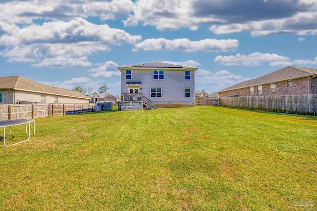 rear view of property with a yard