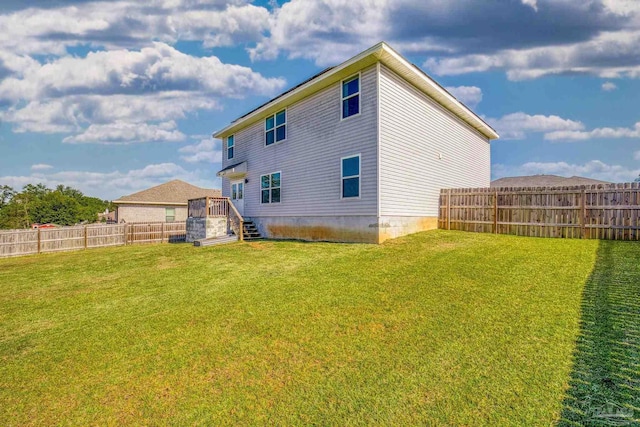 back of house featuring a yard