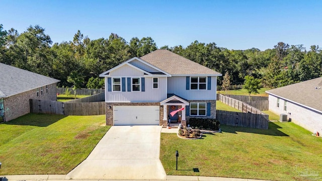 view of front of home with a front yard, a garage, and central AC unit