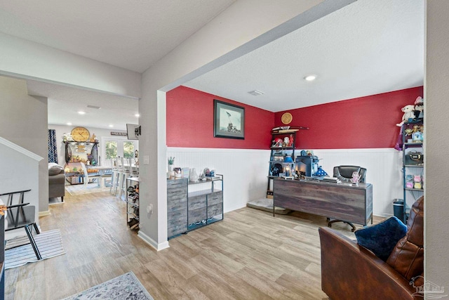 interior space featuring french doors, wood-type flooring, and a textured ceiling