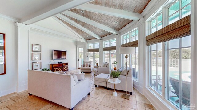living room featuring stone tile floors, high vaulted ceiling, baseboards, and beam ceiling