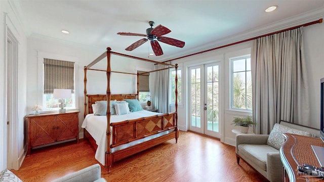 bedroom featuring access to outside, recessed lighting, french doors, crown molding, and light wood-style floors