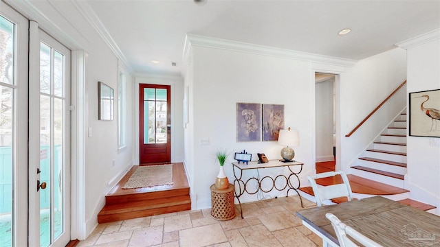 foyer with crown molding, stone tile floors, recessed lighting, stairway, and baseboards