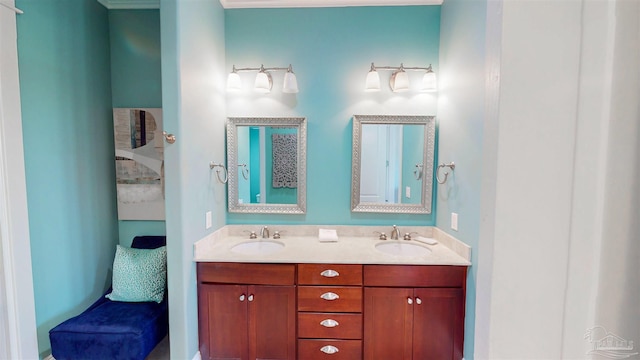 ensuite bathroom featuring double vanity, a sink, and connected bathroom
