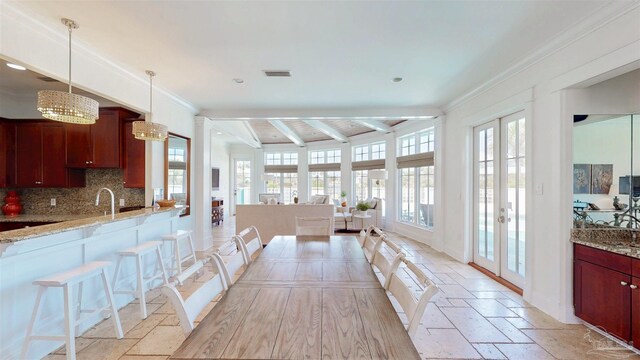 dining space with french doors, crown molding, stone tile flooring, visible vents, and beamed ceiling