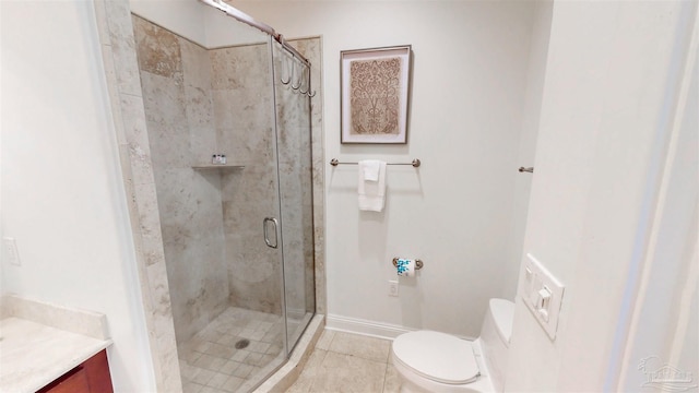bathroom with baseboards, toilet, a shower stall, vanity, and tile patterned floors