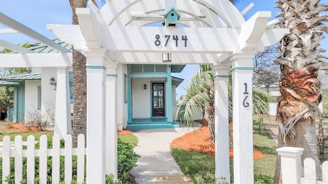 doorway to property featuring fence