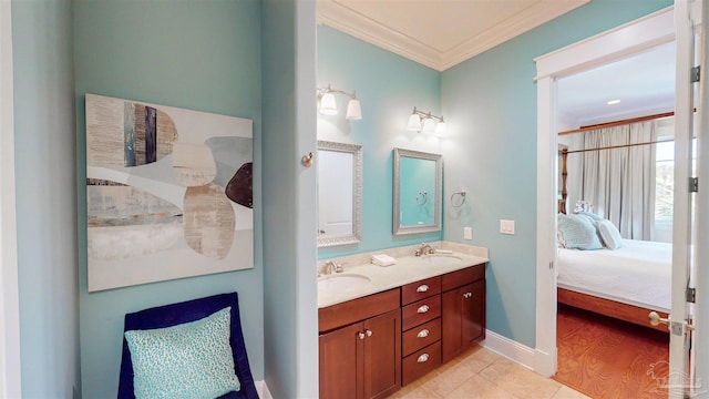 ensuite bathroom featuring tile patterned floors, a sink, ornamental molding, and connected bathroom