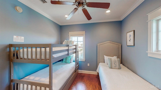 bedroom with baseboards, ceiling fan, crown molding, recessed lighting, and wood finished floors