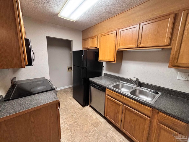 kitchen with a textured ceiling, black appliances, dark countertops, and a sink