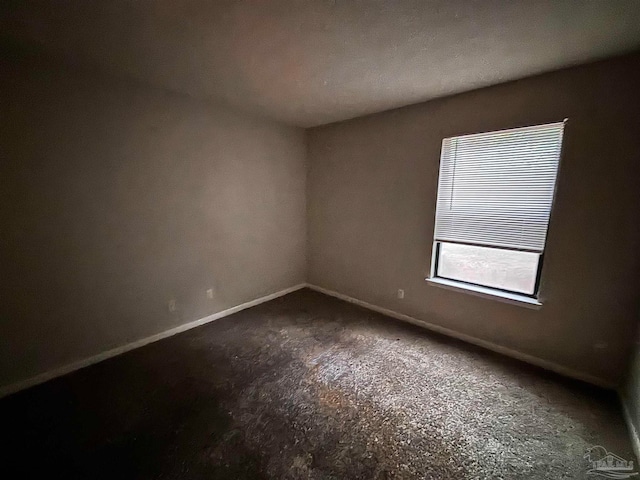 spare room featuring baseboards