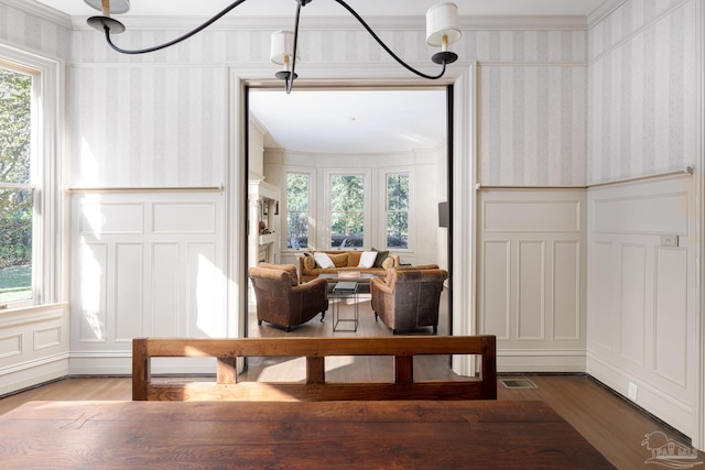 living area featuring hardwood / wood-style floors and ornamental molding