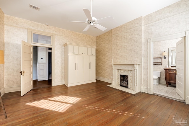 unfurnished living room with hardwood / wood-style flooring, ceiling fan, and lofted ceiling