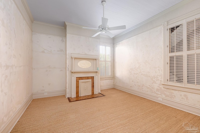 unfurnished living room with ceiling fan, ornamental molding, and light carpet