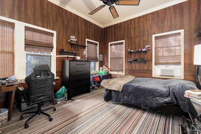 bedroom featuring ceiling fan, cooling unit, ornamental molding, and wooden walls