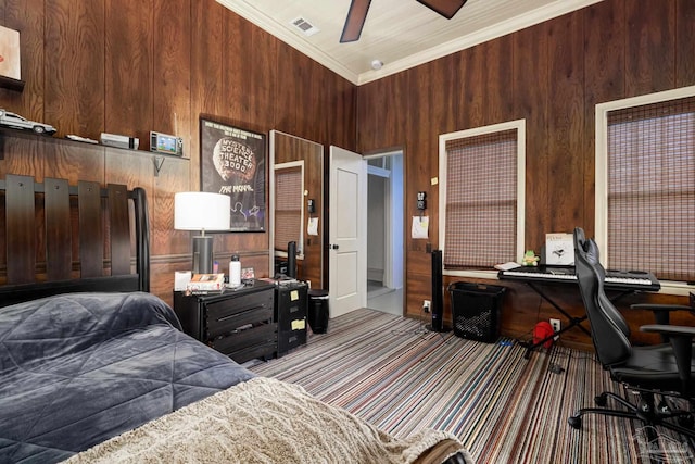 bedroom featuring ceiling fan, wooden walls, a high ceiling, and ornamental molding