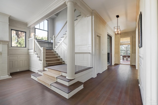 stairs featuring a chandelier, wood-type flooring, and crown molding