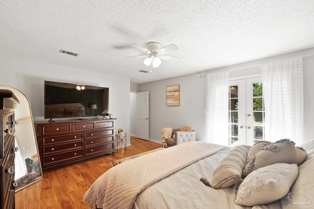 bedroom with access to exterior, french doors, visible vents, and light wood-style floors