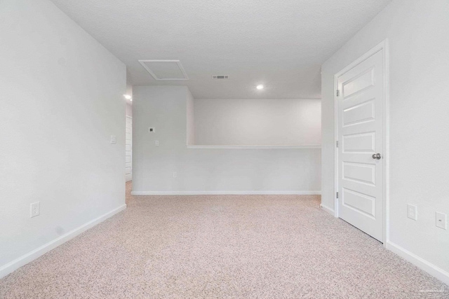 carpeted spare room with a textured ceiling