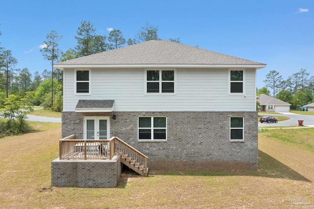 rear view of property with french doors, a yard, and a wooden deck