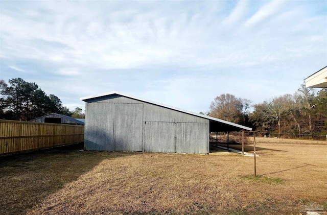 view of outbuilding featuring a yard